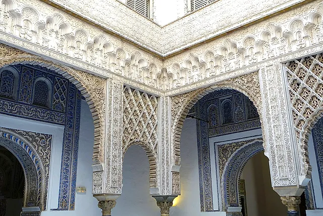 The Patio de las Muñecas with white stucco and lobed arches