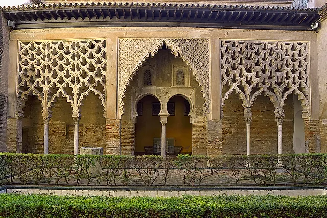 The Almohad portico of the Patio del Yeso, with a stucco lattice and a pool
