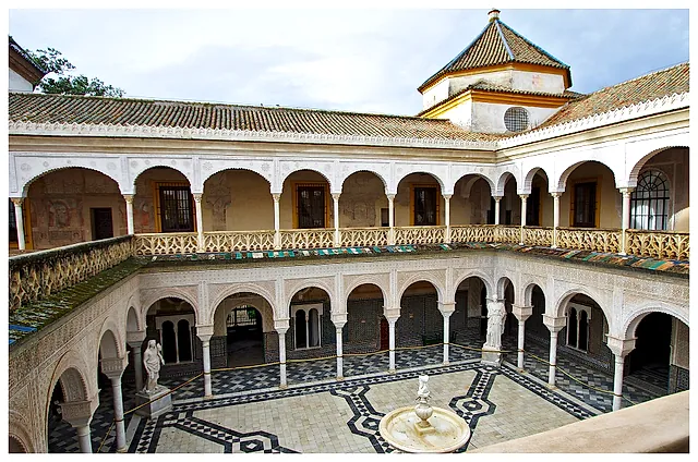 The main patio of the Casa de Pilatos, with a fountain and mosaic paving